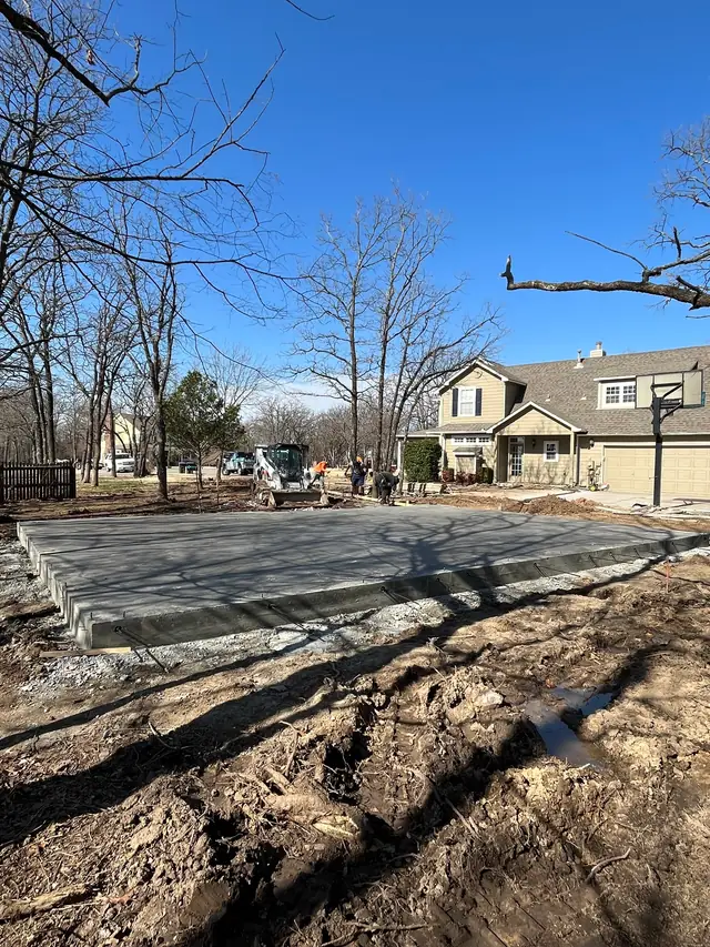 A Driller Roofing and Construction crew pouring a concrete slab on site